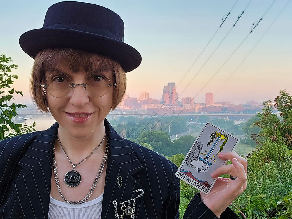 Jen Bateman standing in front of the Saint Paul, Minnesota, skyline in the dawn hours.