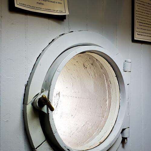 Two Harbors: Red Brick Lighthouse Porthole
